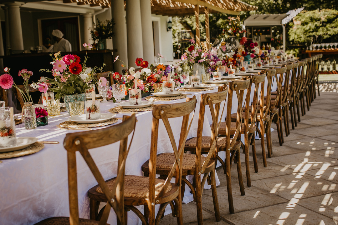 A Wooden Chairs Near the Table with Flowers